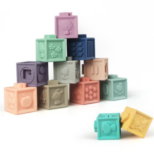 Image of a My First Learning Cubes A set of soft and colorful learning cubes with 3D animal shapes, fruits, numbers, and vibrant patterns.